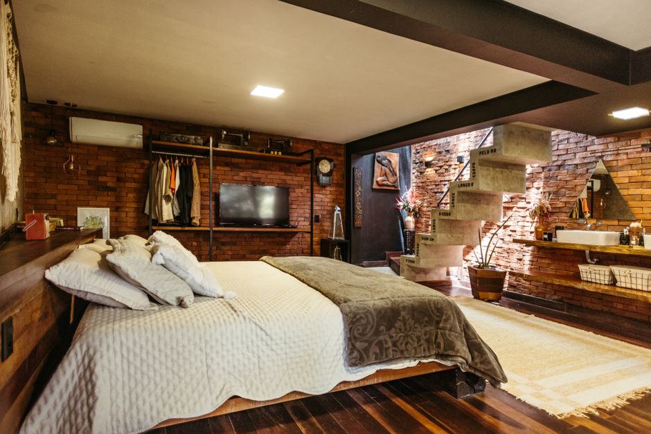 Stylish bedroom in Santa Teresa, Brasil with exposed brick and modern design.