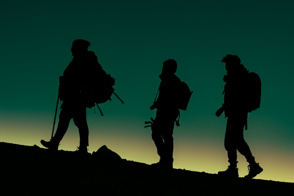 Three hikers silhouetted against the sunset in Toluca de Lerdo, Mexico.