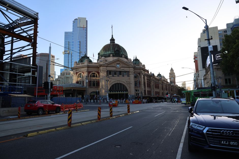 Melbourne's iconic Flinders Street Station captured in the early evening, showcasing classic architecture.