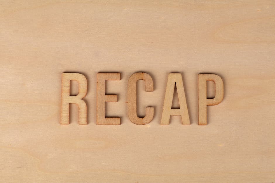 Wooden letters spelling 'RECAP' on a wooden surface, offering a rustic look for presentations.