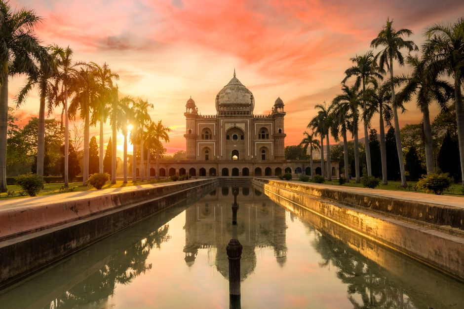 Breathtaking view of Safdarjung Tomb reflecting in the water at sunset in New Delhi, India.