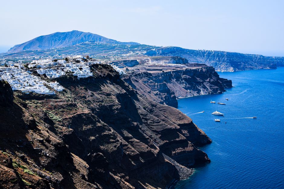 Stunning view of Santorini's white houses on cliffs against the blue Aegean Sea, perfect for travel inspiration.