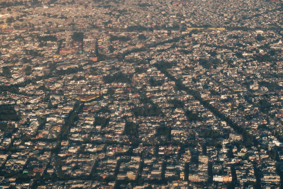 A vast aerial view of a densely populated urban residential area with diverse building types.