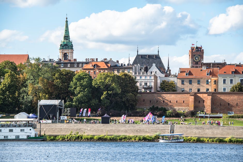 Charming cityscape view featuring historic buildings along a river, perfect for travel and architecture lovers.
