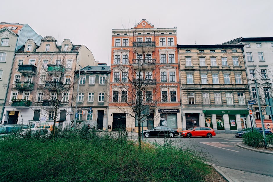 Charming street view of historic residential buildings in Poznań, Poland.